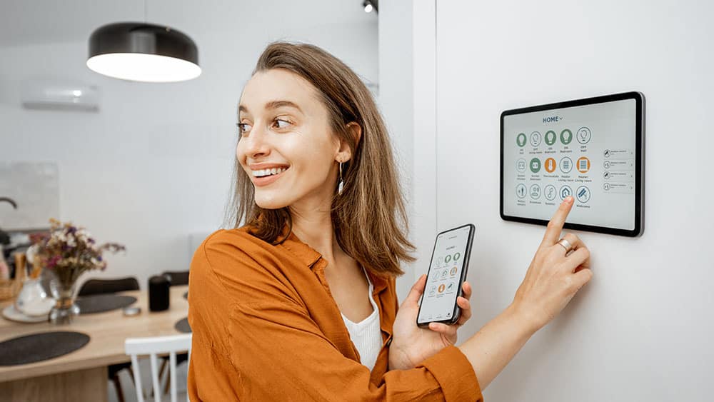 woman controlling smart home appliances Connected & Smart Home Automation – A reality of today